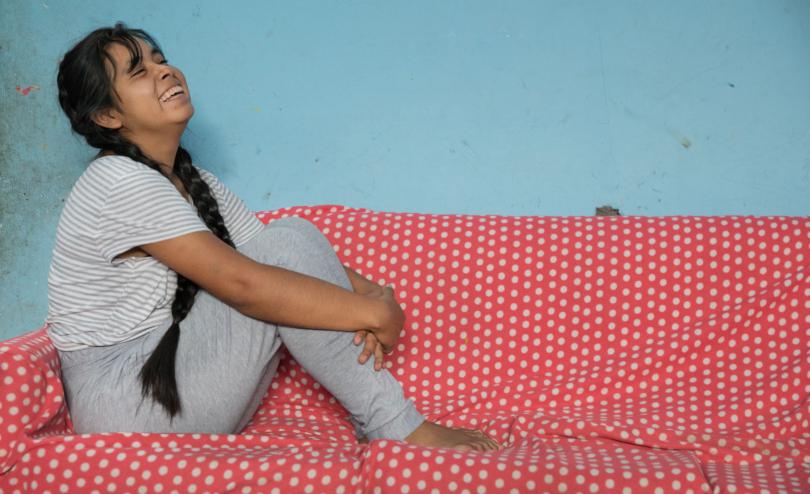 Estefany*, 15, sits in her home in Huanuco, Peru