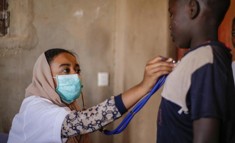 A doctor treats a child during the coronavirus pandemic