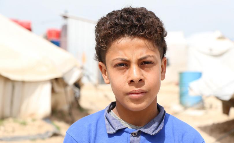 A boy stands in Al Hol in NE Syria