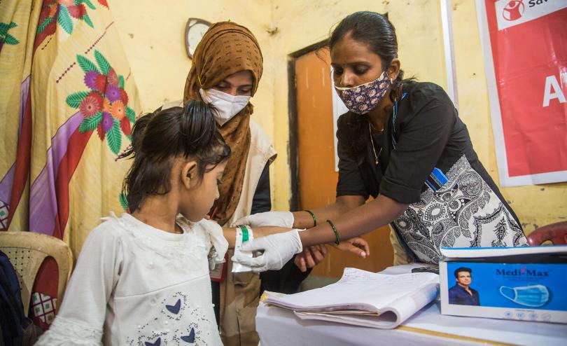 Afreen has her malnutrition status measured with a MUAC band in India