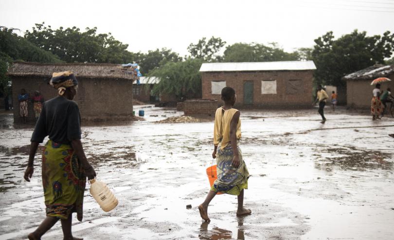  Ethel, 12, collecting water with her grandmother in their displacement camp, Malawi