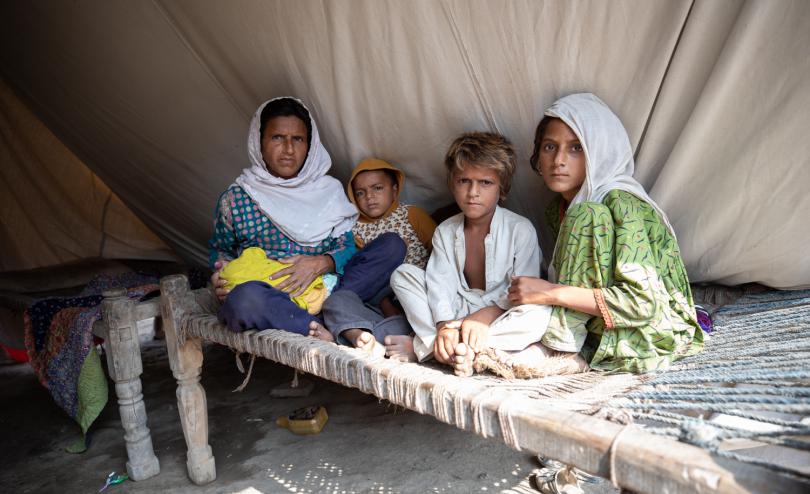 Noor with her children, inside her waterproof tent provided by Save The Children, Sindh, Pakistan