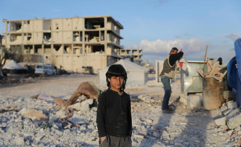  Mamdouh*, 8, standing among the rubble of the neighbourhood where he used to live, and has been destroyed by the earthquake that hit Syria in February 2023