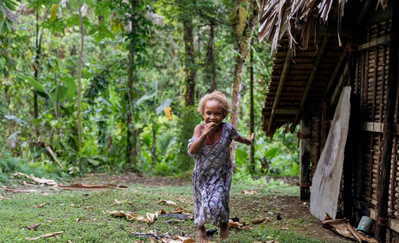 Lucy running through a remote comunity in Malaita Province, the Solom Islands. 