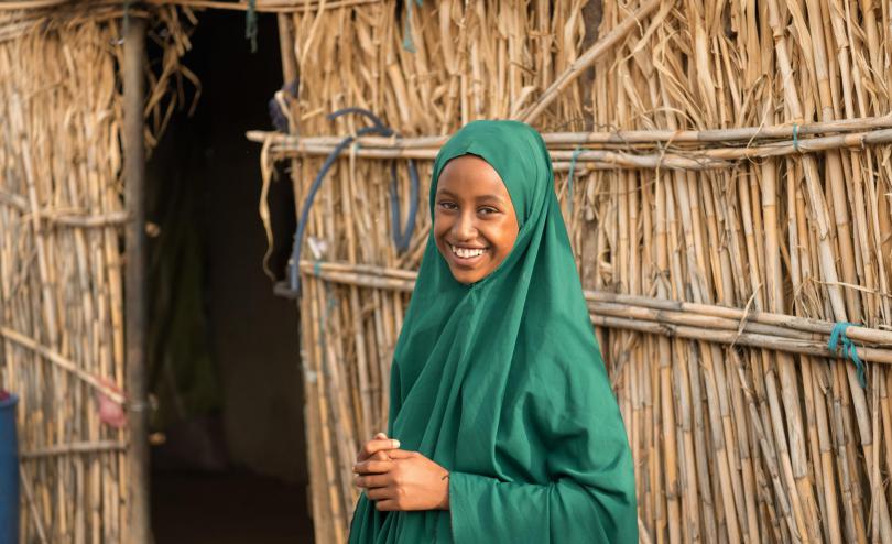 Fardowsa, 12, smiles outside her family's home in the Somali Region