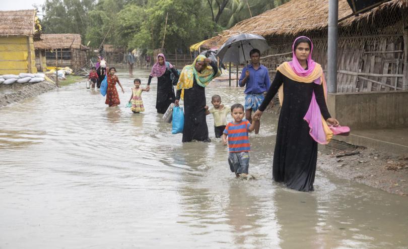 Families wade through flood water