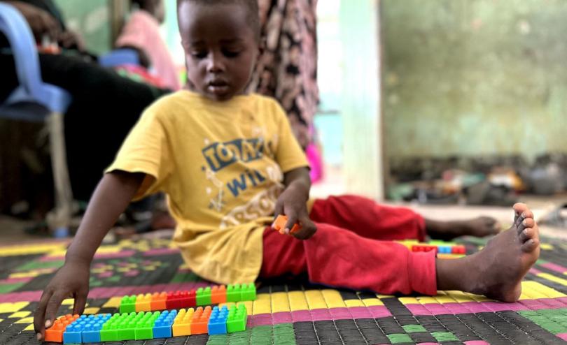 Hani* playing with blocks in the Child Friendly Space, run by Save the Children, in Gezira State, Sudan