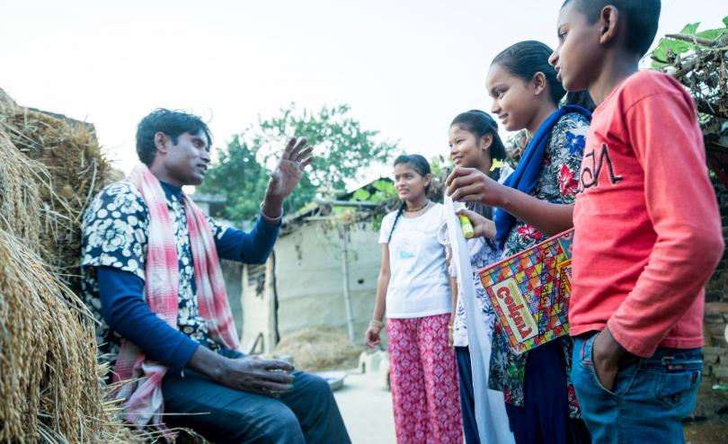 Children in Nepal discuss their rights with an adult