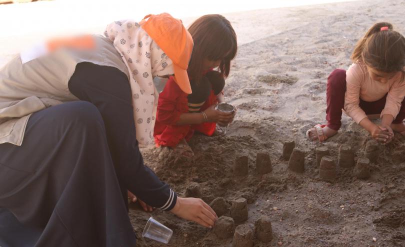 Social worker playing with children in North East Syria