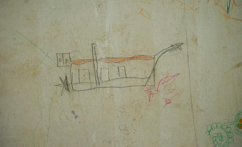 Children drew some boats on the wall of a room in the Rohingya camp in Aceh