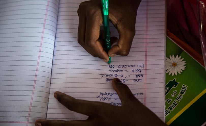 Child writes in school book