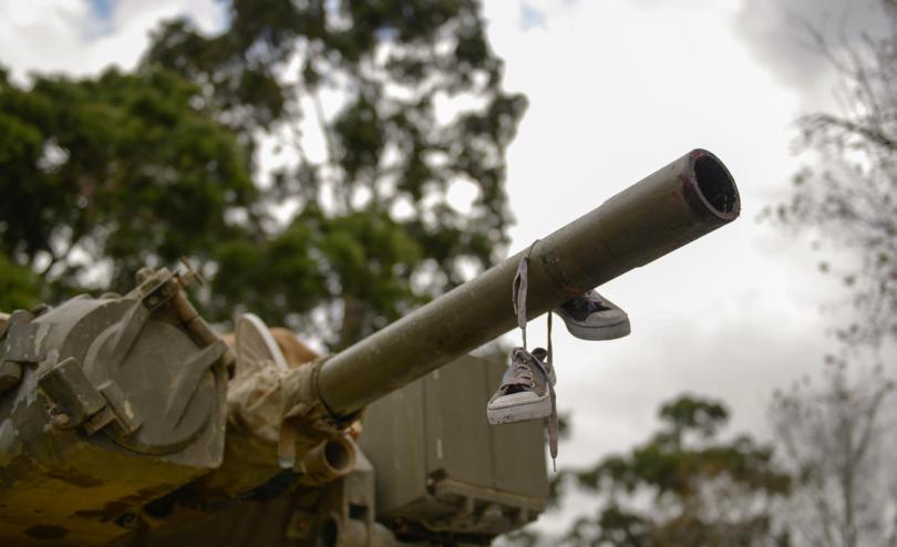 Children's shoes hanging on a tank's cannon, from Save the Children Australia's launch of Stop The War On Children