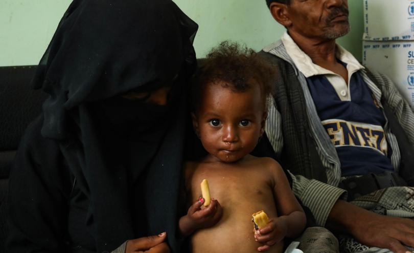 Badour* 15 holding her half sister, Abir*, 20 months old, at a Save the Children supported hospital in Amran