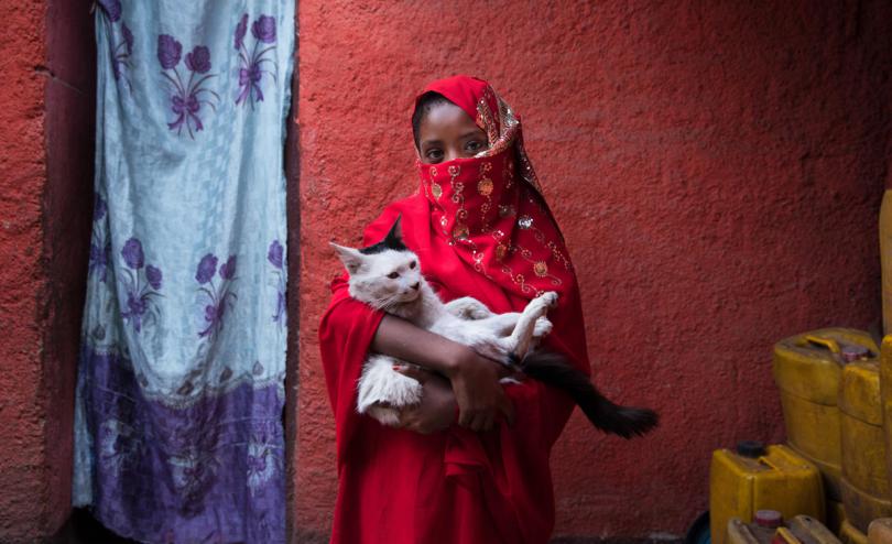 Saada*, 10, with her cat in her home in Harar, Ethiopia. She attends a girls’ club at her school, which empowers girls and boys to talk openly about female issues, from child marriage and FGM to sanitation and menstruation.
