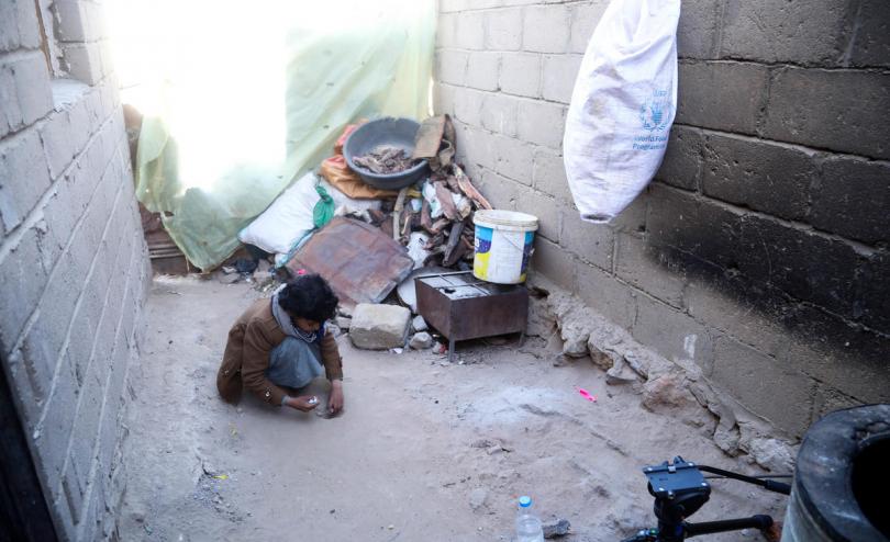 Abed*, 11, plays with marbles outside his home