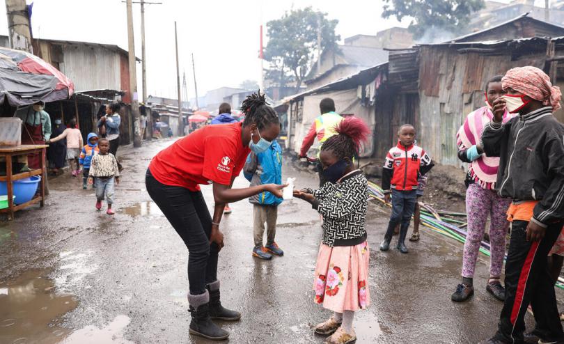 A child in Mathare sanitizing their hands