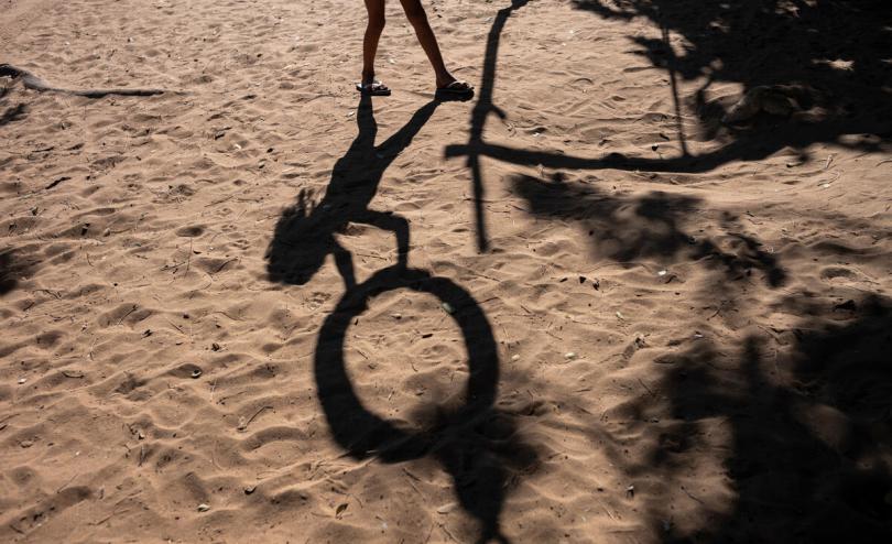 The shadow of a child playing in the park where Camila*, 10, plays with her family and friends in Maicao, Colombia