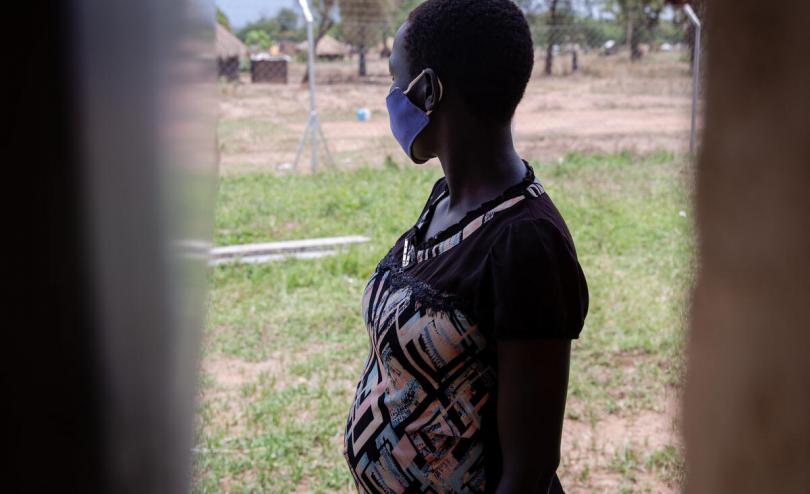 16 year old Sunday* outside the Child Friendly Centre at the school in the Refugee Settlement where she lives.