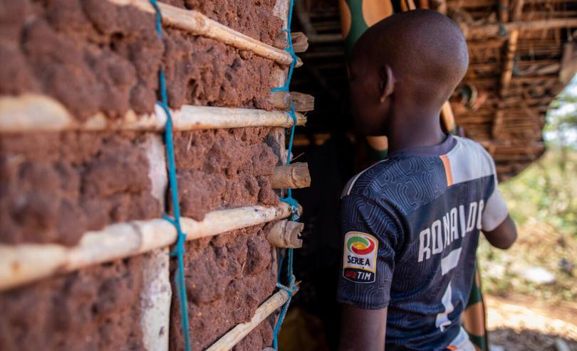  Luis* (14) lives with his neighbour Andre* (71) after his father was killed when armed men attacked his village in Cabo Delgado, Mozambique