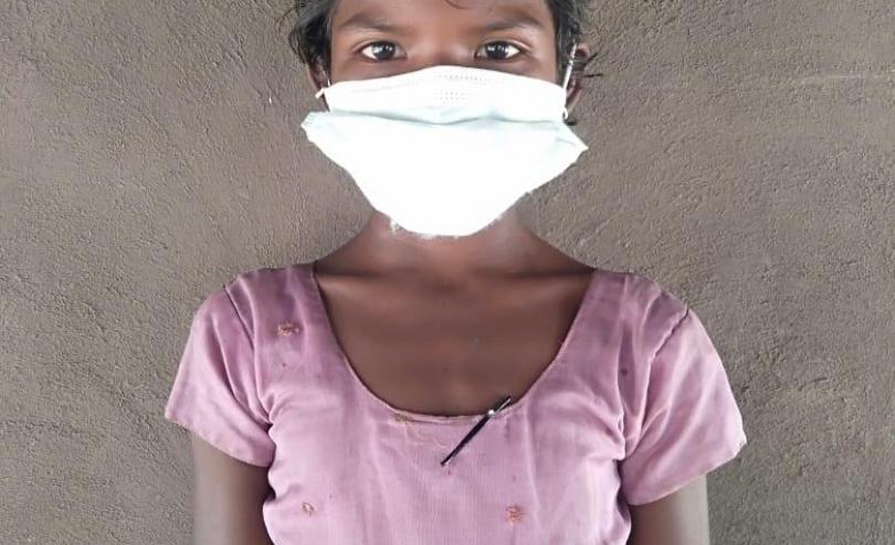 Seetha* 9, in India, wearing a facemask.