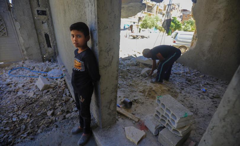 Yaseen* 12 with his father Fawaz* 43, in the house they are rebuilding