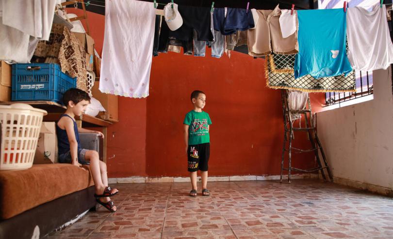 Said*, 6 (in green) and his brother Jad*, 5, at the new home they had to relocate to after their old house was destroyed in the Beirut blast