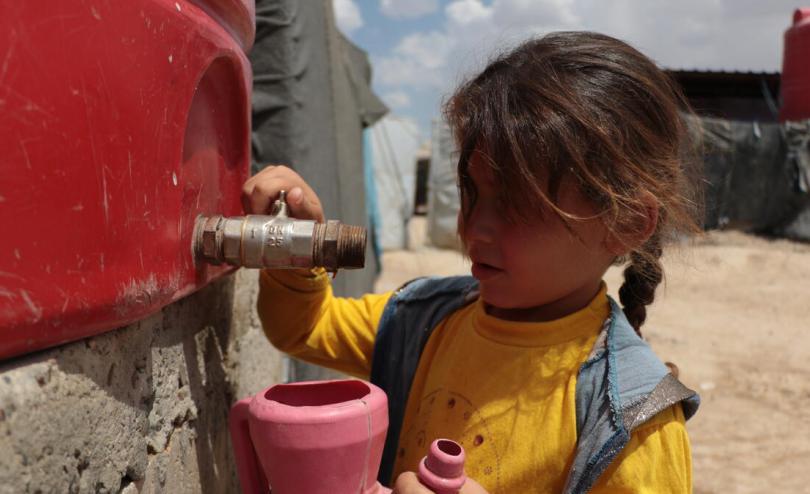 Zaina*, 6 fetching water from the tank in Al Hol camp, north east Syria