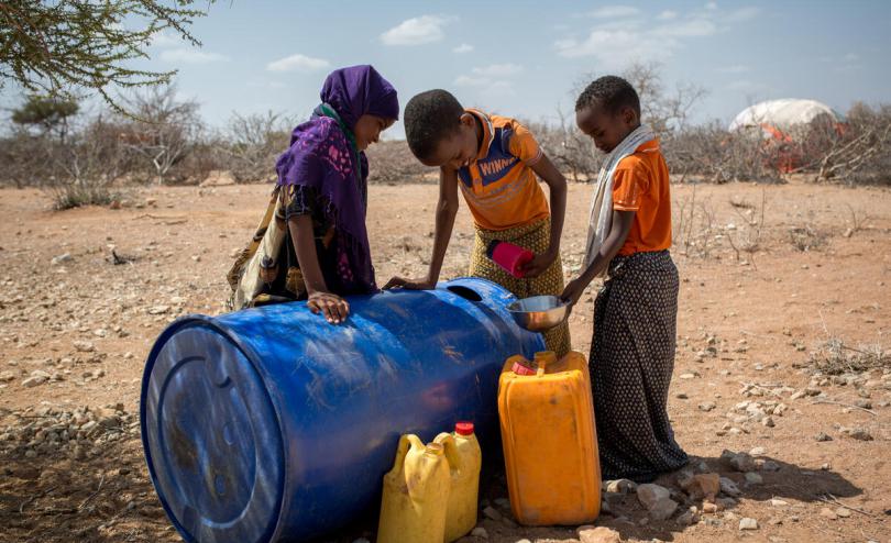 Kayd*, Omar*'s son, and his siblings collect water in Beledweyne district, southern Somalia.