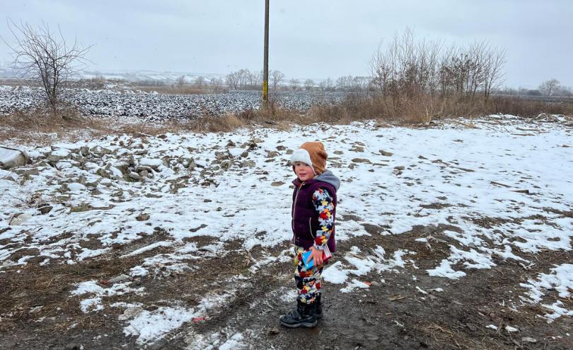 Yuriy* 3, looks out into the snow at the Romanian border