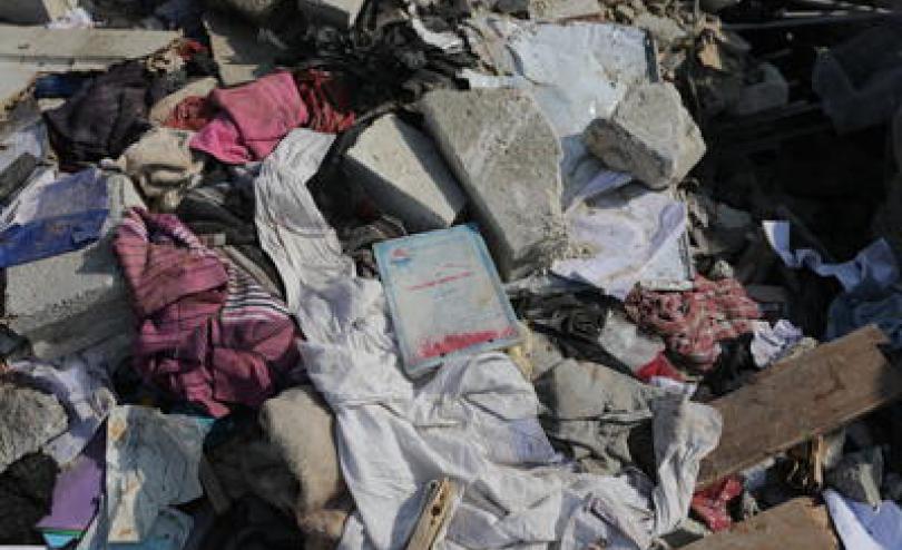 school books and clothes in the rubble of earthquake