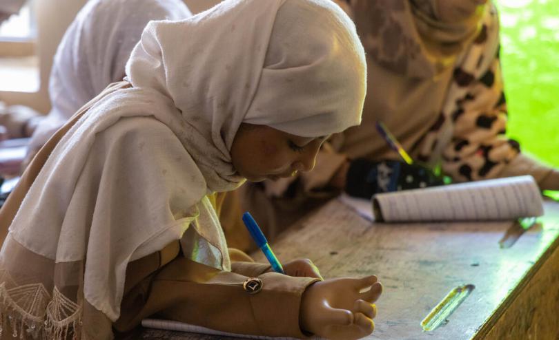 Maha*, 10, pictured at school with her prosthetic hand after being severely injured by a landmine while collecting firewood with her 16-year-old sister, Maya*, in Taiz, Yemen