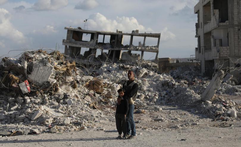  Diaa*, 51, and his son Mamdouh*, 8, among the rubble of what was once the neighbourhood where they lived before it was destroyed by the earthquake that hit Syria