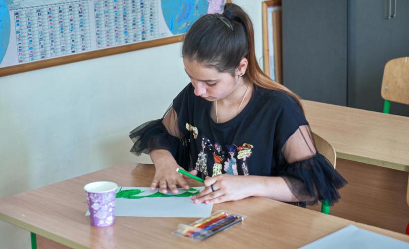 Kramatorsk railway station survivor Zoriana*, 12, is drawing her home in Kramatorsk at her school in a village in western Ukraine