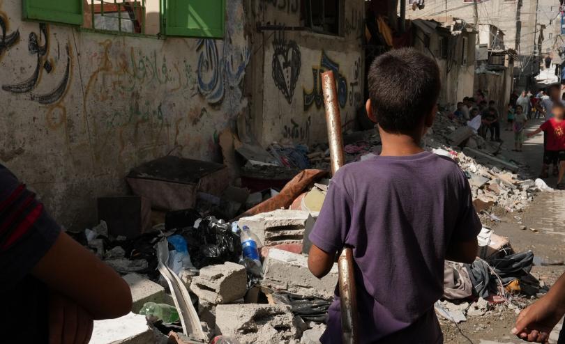 a child standing among the rubble in Gaza