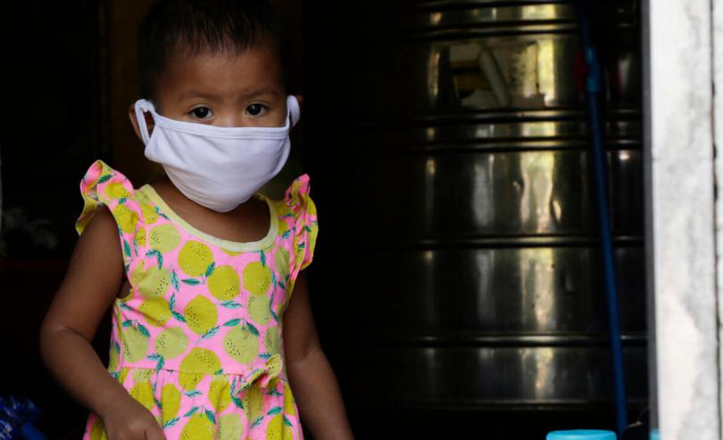 Althea* from the Philippines, 19 months, at the water refilling station where her parents work.