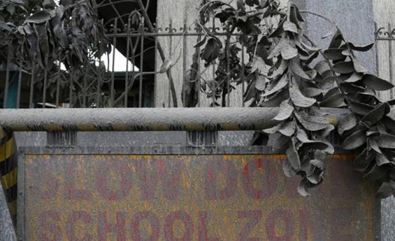 An ash-covered school sign in the town of Laurel, Batangas