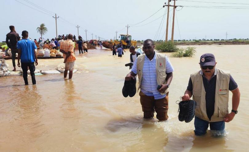 Sudan Country Director Arshad Malik crosses a submerged road in Gezira State (Credit: Ahmed Kodouda / Save the Children)