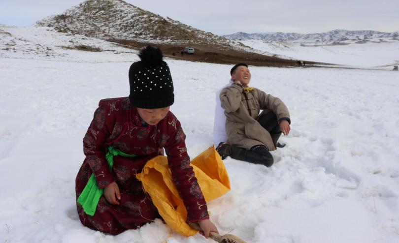 Children playing in snow in Mongolia