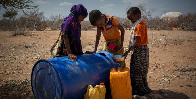 Kayd*, 9 and his siblings fetching water in Beledweyne, southern Somalia