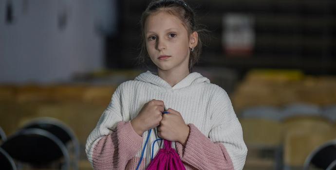 Mariya* with her grab bag in her school shelter in Kyiv
