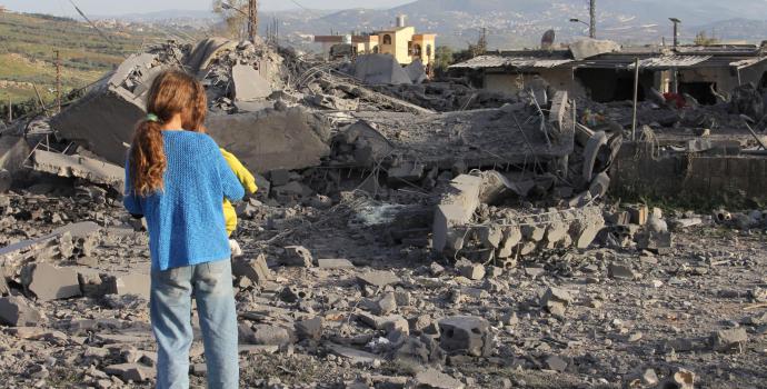 A girl inspects the damage to a building a day after an Israeli airstrike in a village in southern Lebanon on March 6, 2024.