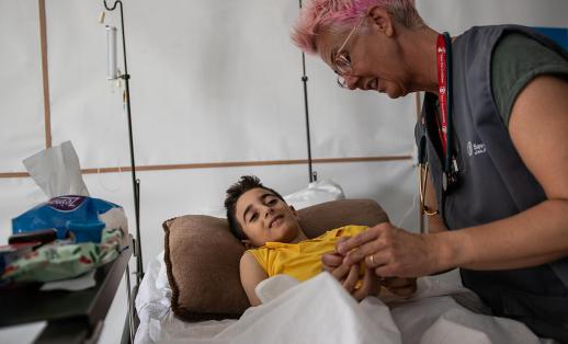 Emergency Health Unit Nurse Becky Platt attends to Ahmed* (10) at a hospital in the Gaza Strip