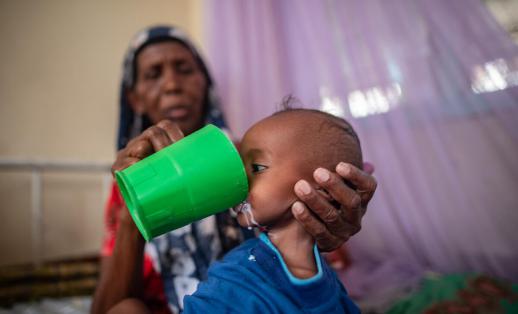 Tasnim,63, feeds milk to her severely malnourished six-month-old grandson