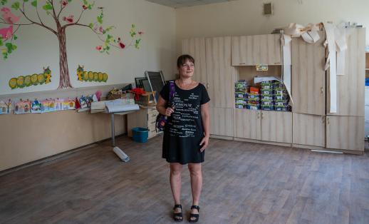Olesia poses for a photo in the middle of her classroom at a damaged school in Mykolaiv, Ukraine