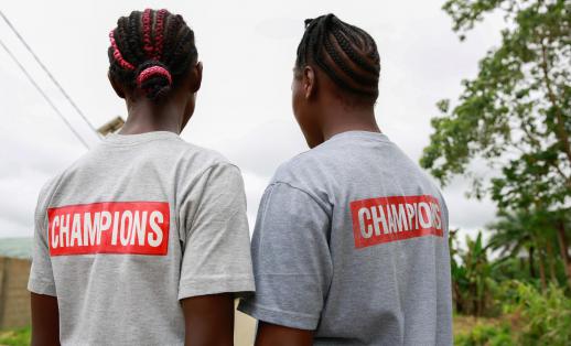 Cousins Kuji*, 19 and Kpemeh*, 18 wear their Ending Child Marriage Champion t-shirts in Kailahun, Sierra Leone.
