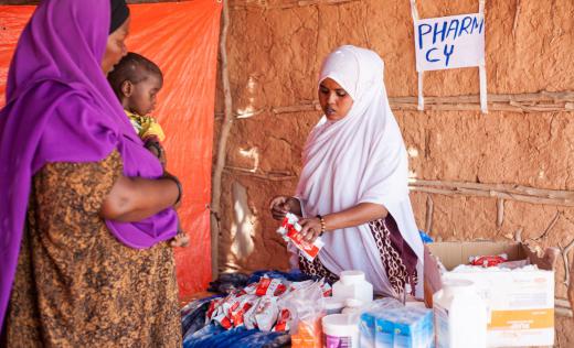 A medical staff member speaks to a mother and child in Somalia