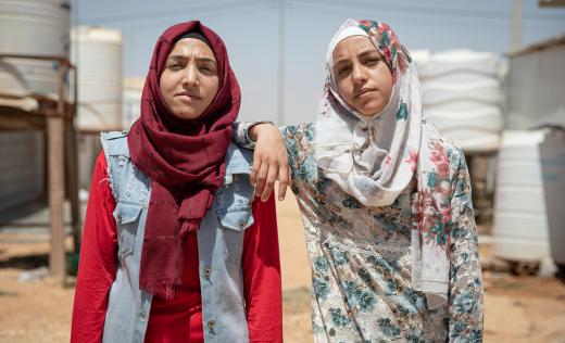 Hiba, 17, and Rama, 14, pose for a portrait in Za'atari camp for Syrian refugees, Jordan