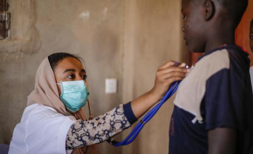 A doctor treats a child during the coronavirus pandemic
