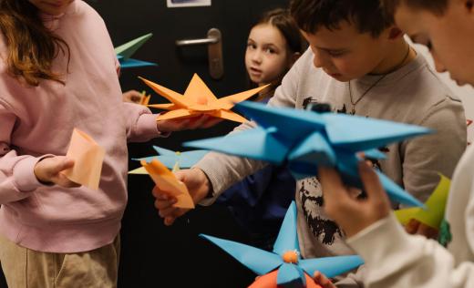 children playing with paper toys in Romania