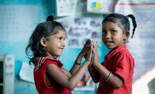 Girls play and hold hands